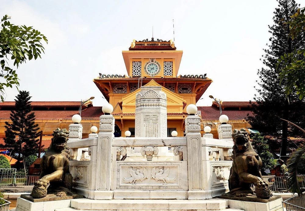 Exterior view of Binh Tay Market in Cholon Saigon featuring the iconic yellow walls and central clock tower