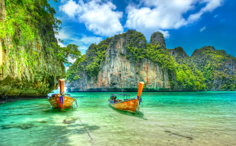 Phang Nga Bay Thailand limestone cliffs traditional longtail boat