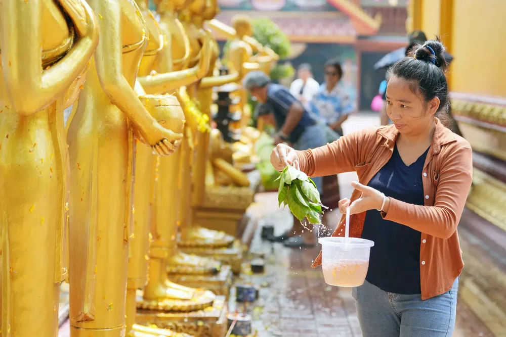 A vibrant pagoda scene during a cultural celebration in Laos