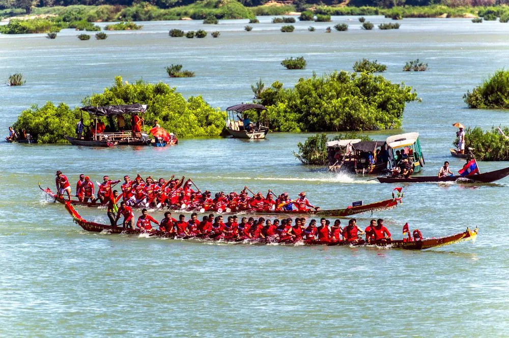 Colorful traditional boats racing on the Mekong River during a Laos festival