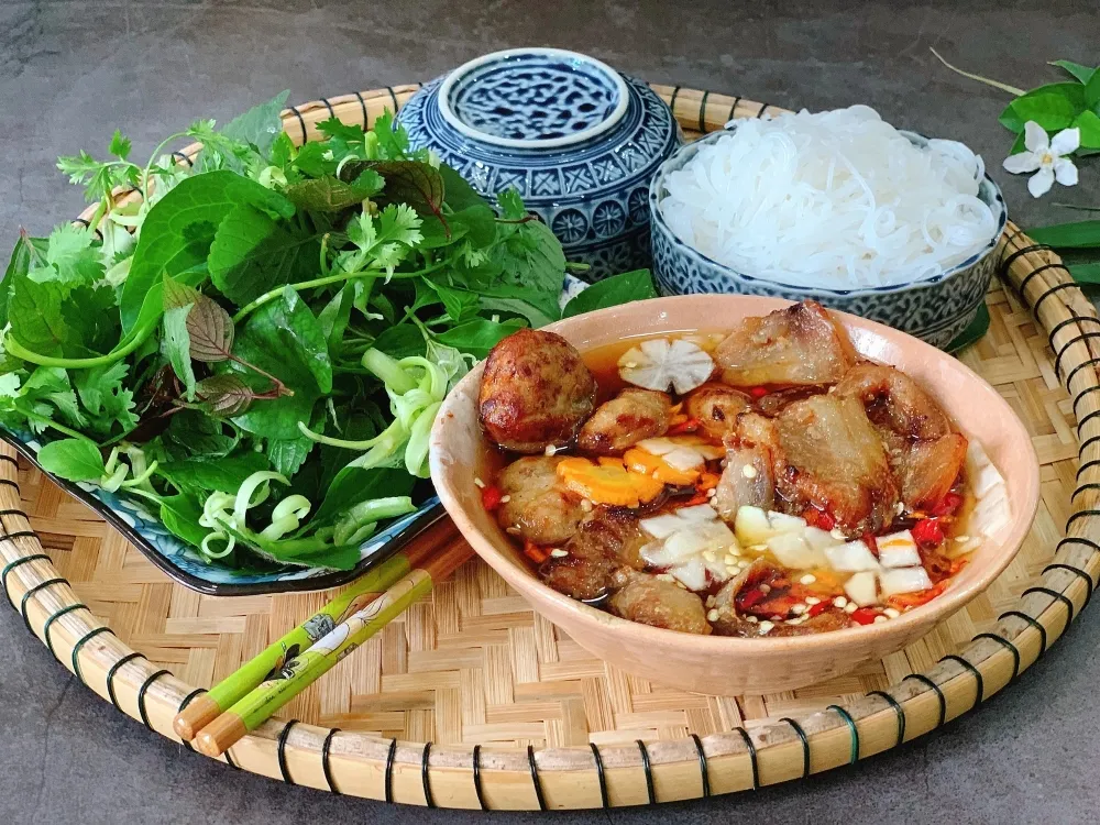Bun Cha with grilled pork patties, dipping sauce, vermicelli noodles and fresh herbs