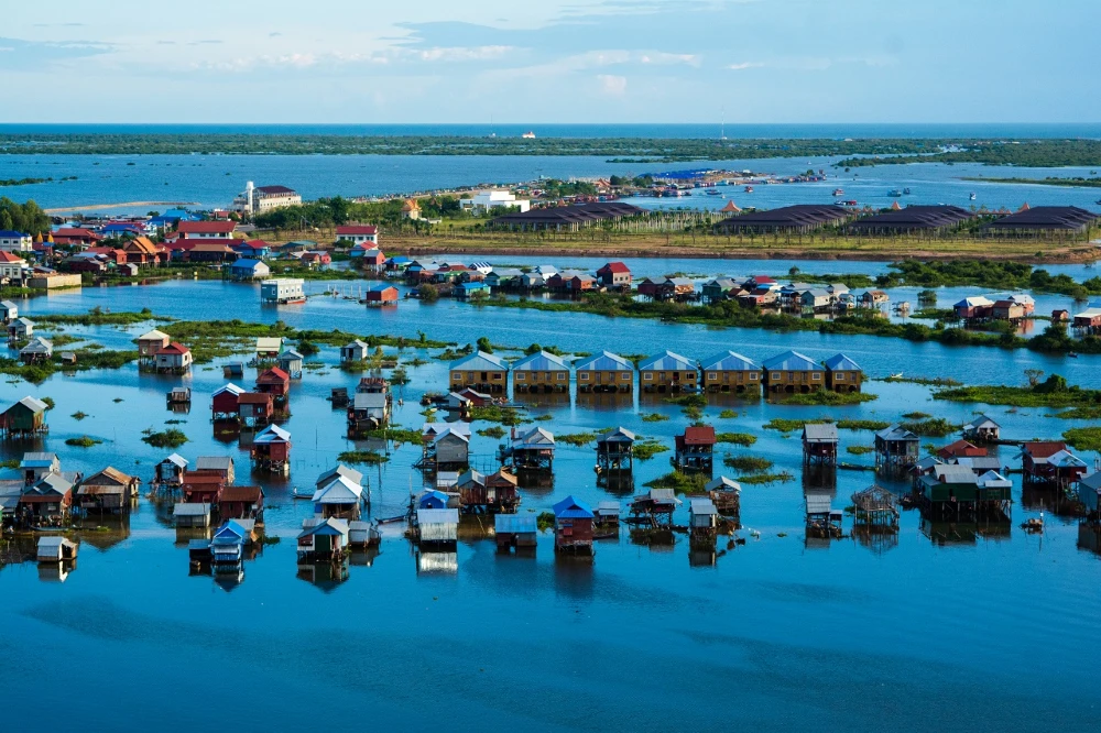 Traditional wooden boat cruising on Tonle Sap Lake near Siem Reap