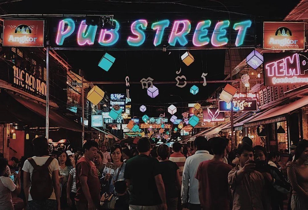Vibrant nightlife and neon signs on Pub Street in downtown Siem Reap