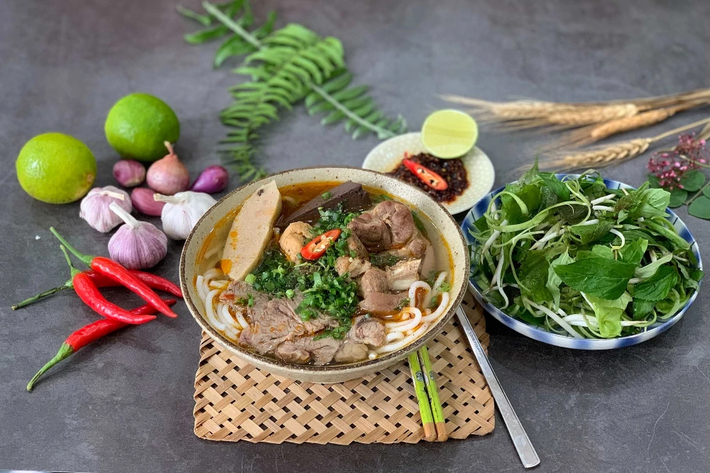 Authentic Bun bo Hue beef noodle soup with fresh herbs