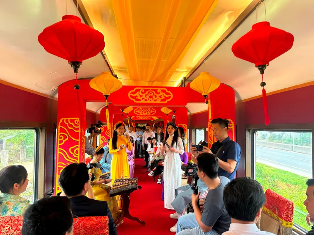 Onboard cultural performance of ca Hue in the decorated carriage of the Vietnam heritage train