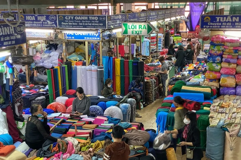 Local vendors selling fabric at Dong Xuan Market in Hanoi