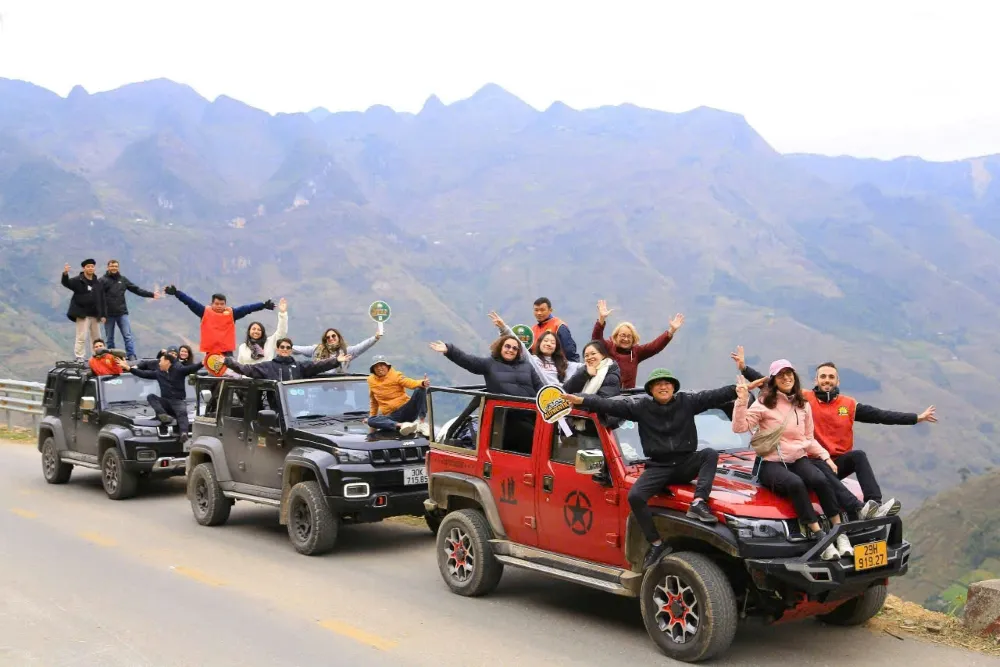 Adventure travellers riding motorcycles through the foggy mountain passes of Northern Vietnam in February