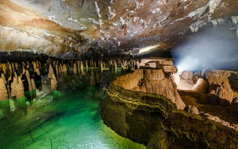 cone-shaped stalagmites and reflective underground pools in va cave large cave vietnam