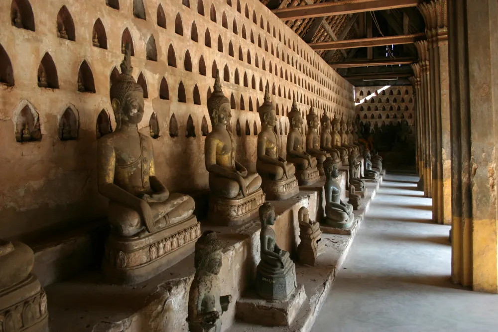 Thousands of small Buddha statues in the wall niches of Wat Sisaket temple cloister