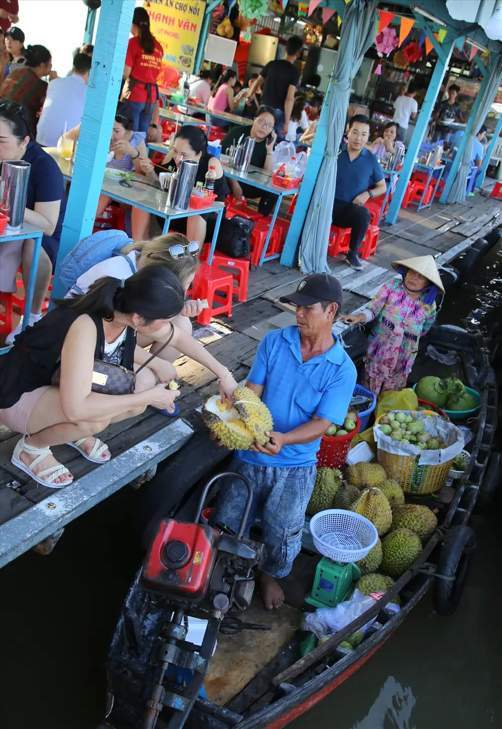 buying fruits on long xuyen floating market