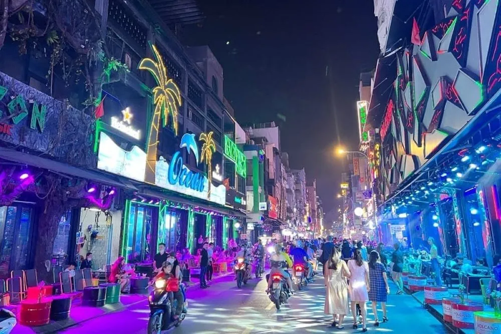 night view of Bui Vien Walking Street with neon signs and crowds 