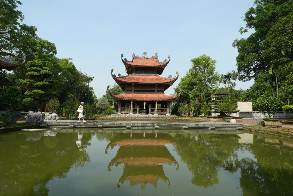 Traditional Vietnamese Nom Pagoda near Hanoi reflected in a peaceful pond