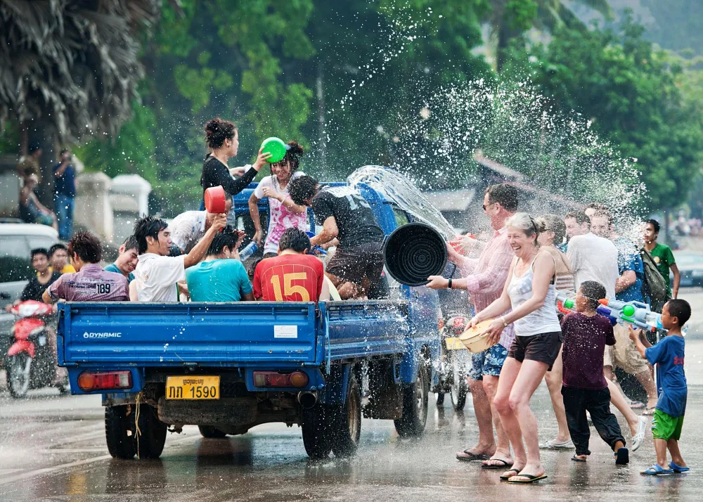 Cheerful crowds participating in the Boun Songkran water festival on the streets of Laos
