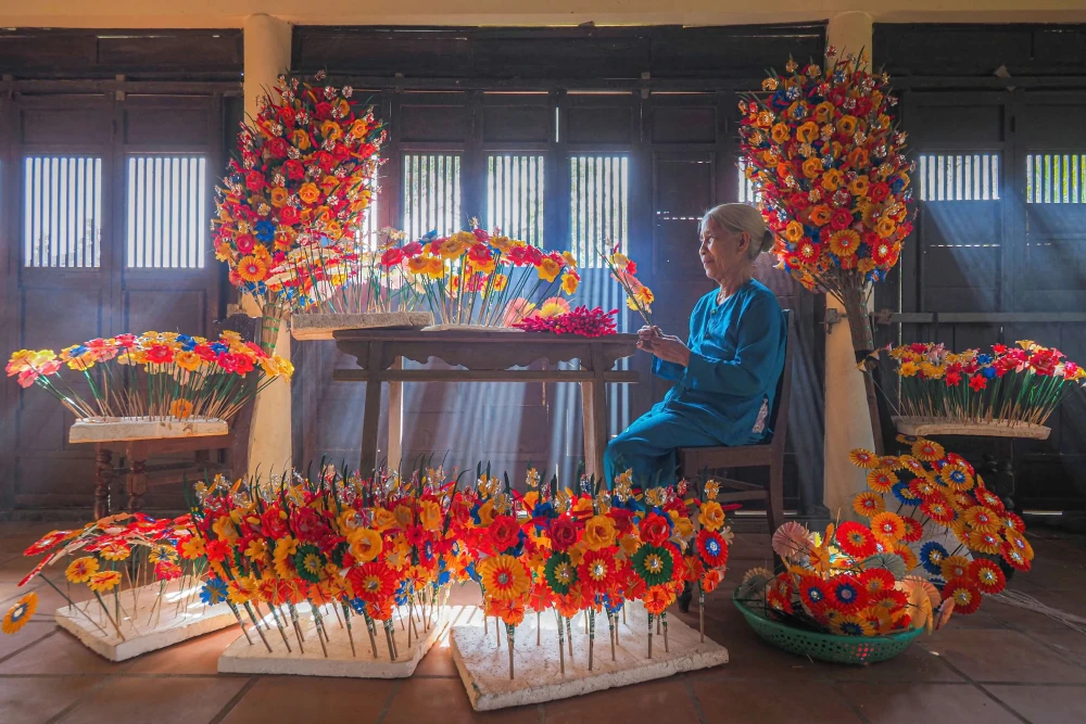 Handcrafted colourful paper lotus flowers for spiritual rituals at Thanh Tien village