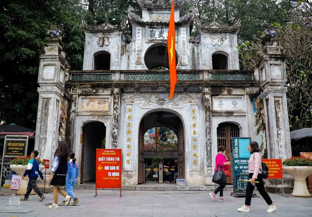 Quan Thanh Temple shaded by old banyan trees