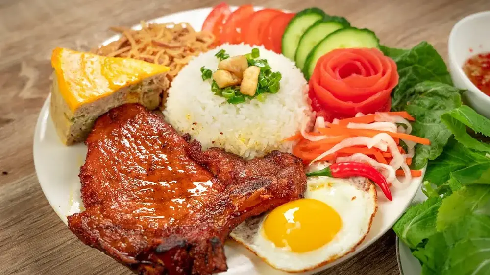 Com Tam broken rice with grilled pork iconic Saigon street food