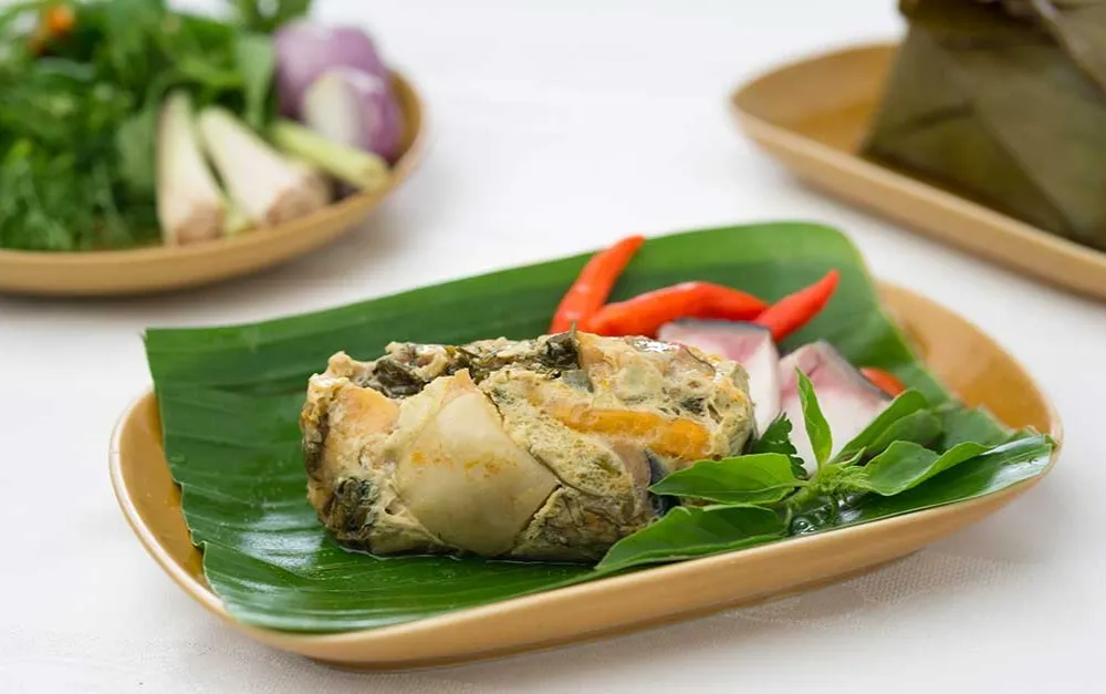 Mok Pa steamed fish curry seasoned with herbs and spices, beautifully wrapped and cooked inside banana leaves