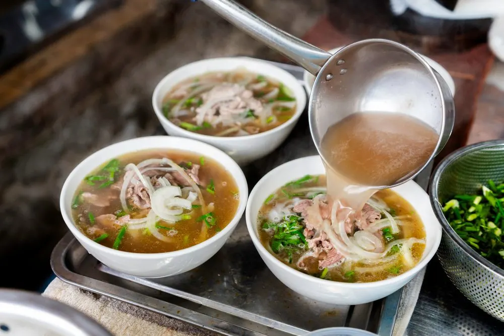 Steaming bowl of pho at a street-food stall in Hanoi