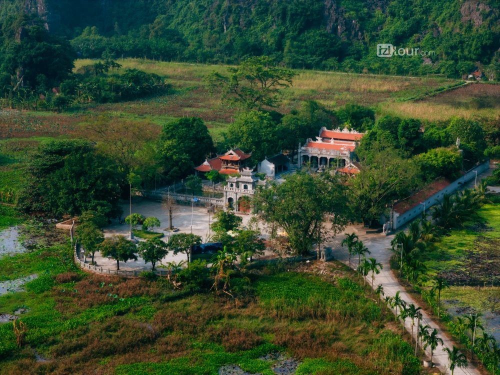 Thai Vi Temple in Ninh Binh, surrounded by limestone mountains and rice fields.