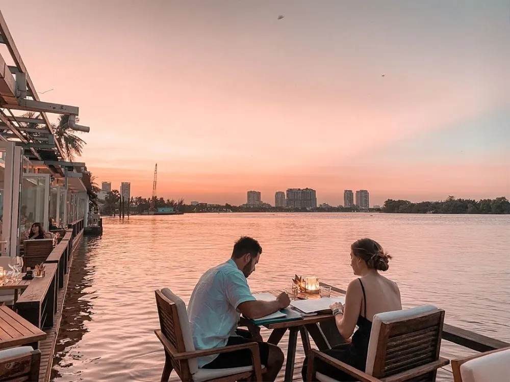 enjoy a romantic meal at a riverside restaurant