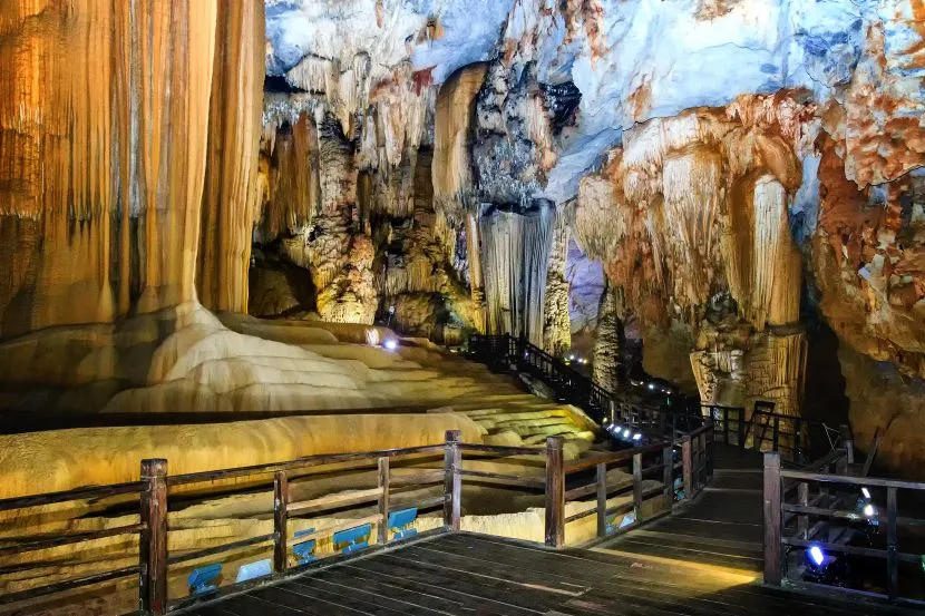 breathtaking limestone formations and golden lit stalactites inside paradise cave vietnam