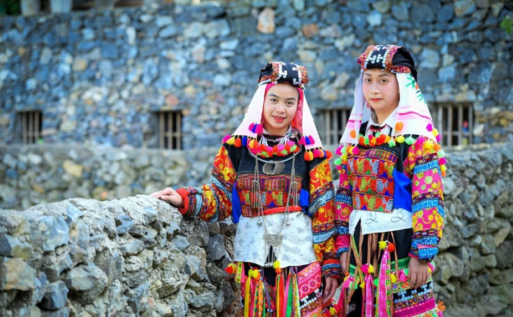 Lolo woman in traditional costume decorated with colourful geometric patchwork in Cao Bang Vietnam