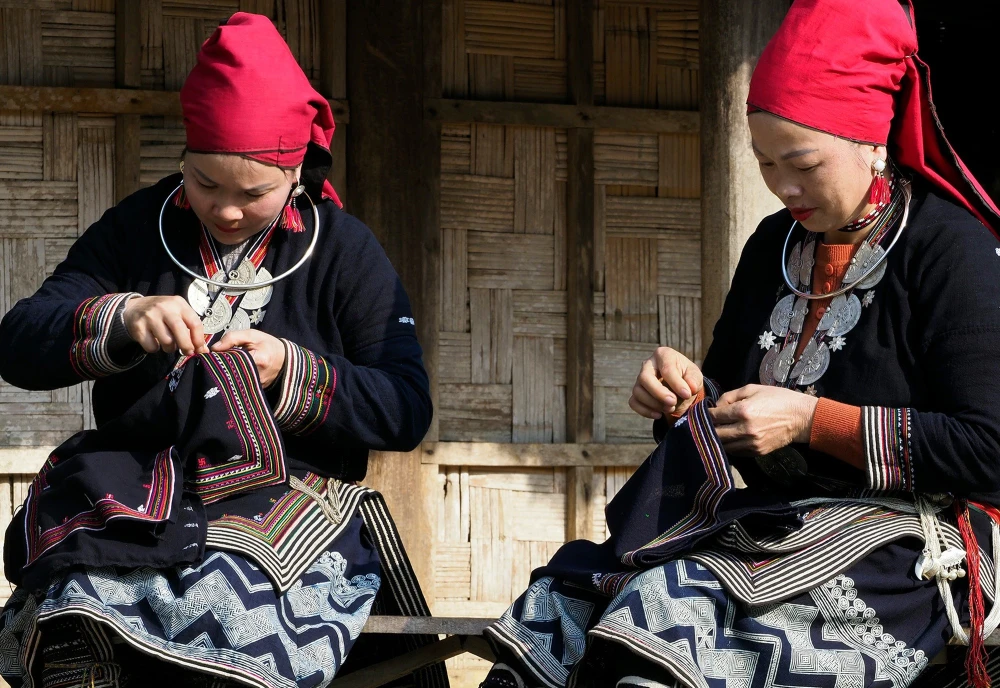 Hmong women weaving traditional fabric in the mountains of northern Vietnam