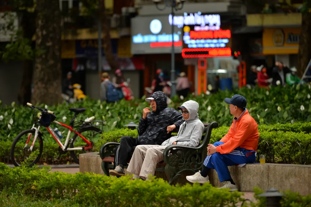 Hanoi residents wearing light jackets on a cool December morning
