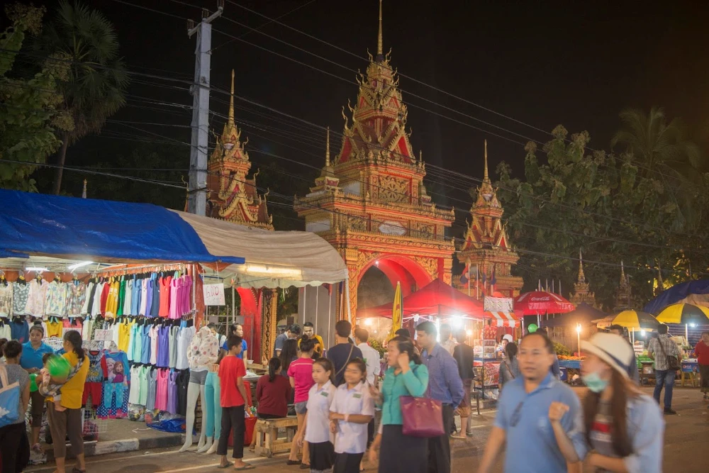 Vibrant red tents of the Vientiane Night Market along the Mekong riverside at night